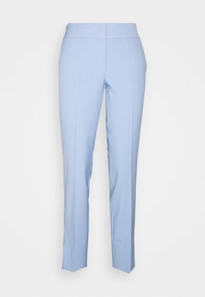Pantalons bleu clair, fuselés avec une taille plate, sans fermetures visibles, texture lisse et de subtils plis marqués le long de l'avant.