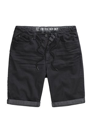 Černé džíny šortky s elastickým páskem na šňůrku, ohrnutými manžetami, přední kapsou a slim-fit designem. Tkanina vypadá hladce s mírnou strukturou.