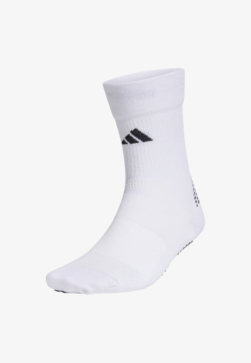 White athletic sock with ribbed cuff, featuring black Adidas logo and small textured dots on the bottom for grip.
