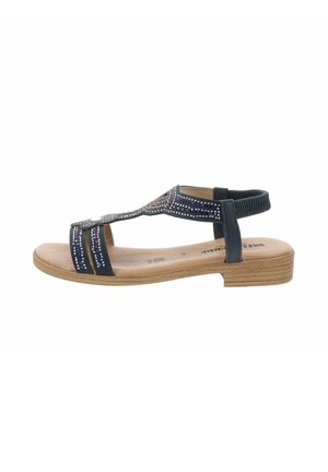 Sandal blu con decorazioni, suola piatta e cinturino posteriore. La parte superiore ha una finitura texturizzata con strisce a contrasto.