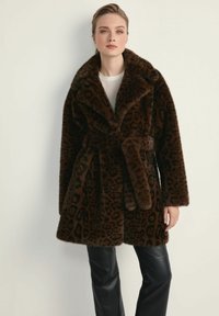 Kożuch z futra syntetycznego w leoparda w ciemnym brązie, z szerokim kołnierzem, paskiem i kieszeniami bocznymi. Miękka tekstura i luźny krój.