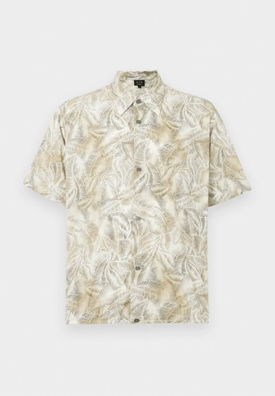 Chemise à manches courtes en beige clair avec un motif de feuilles de palmier. Dotée d'un col, d'une fermeture à boutons et d'une texture de tissu douce.