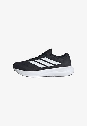 Scarpa da corsa Adidas nera con tre strisce bianche e suola spessa bianca e imbottita su sfondo bianco.