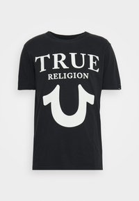 T-shirt en coton noir avec un col rond, arborant un texte en lettres blanches audacieuses qui dit "TRUE RELIGION" et un grand graphique de logo blanc en dessous.