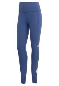 Leggings de sport bleus à taille haute, fabriqués en tissu lisse. Dotés d'une poche latérale et d'un logo réfléchissant sur la partie inférieure de la jambe.