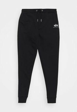 Schwarze Sweatpants aus einem Baumwollgemisch, mit einem elastischen Bund, Kordelzug und gerippten Bündchen. Enthält ein kleines weißes Logo am Oberschenkel.