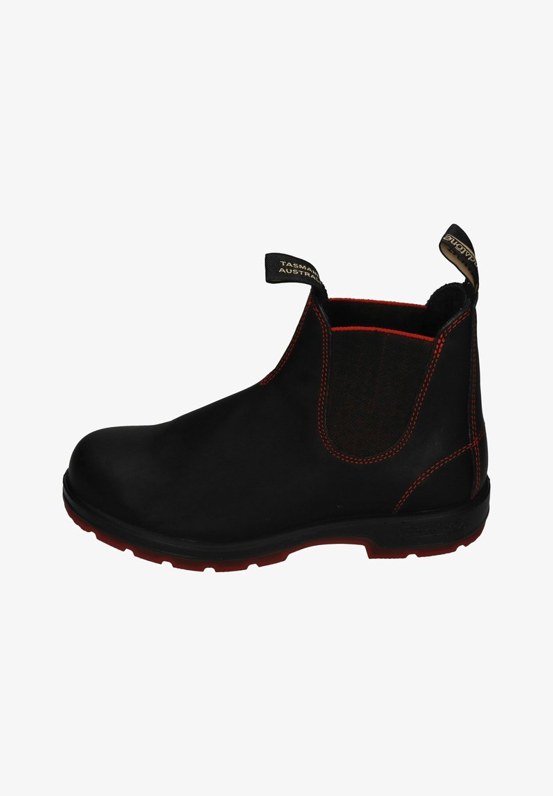 Black ankle boot with elastic side, red stitching, and durable material. Features a textured fabric panel and a rubber sole with red accents.