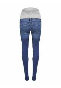 Jeans ajustados con una cinturilla de jersey gris claro, material de mezclilla azul oscuro, cinco bolsillos y una textura suave en toda la tela.