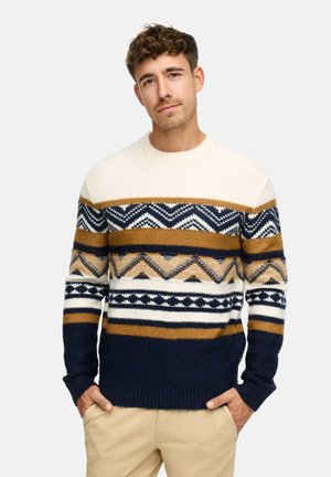 Pull en tricot avec des motifs géométriques en crème, bleu marine, or et blanc. Manches et ourlet côtelés ; encolure ronde. Texture douce.