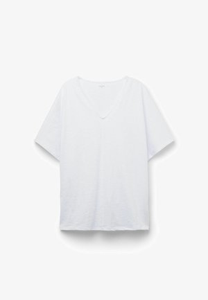 T-shirt blanc à manches courtes avec col en V, ourlet droit et tissu légèrement texturé, posé à plat sur un fond blanc.