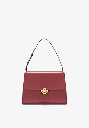 Burgundy leather handbag with a structured flap, gold circular clasp, and adjustable shoulder strap.