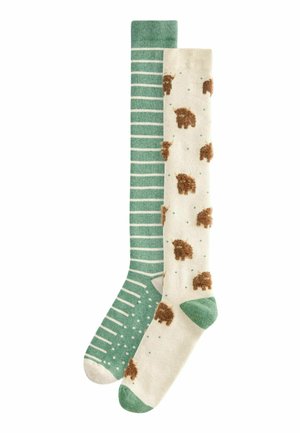 Knee-high socks; one green with white stripes, the other cream with brown animal designs and green accents. Soft texture, playful patterns.
