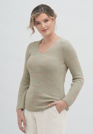 V-neck sweater in soft, textured knit, featuring a blend of green and peach hues. Long sleeves and a fitted silhouette. Paired with light pants.