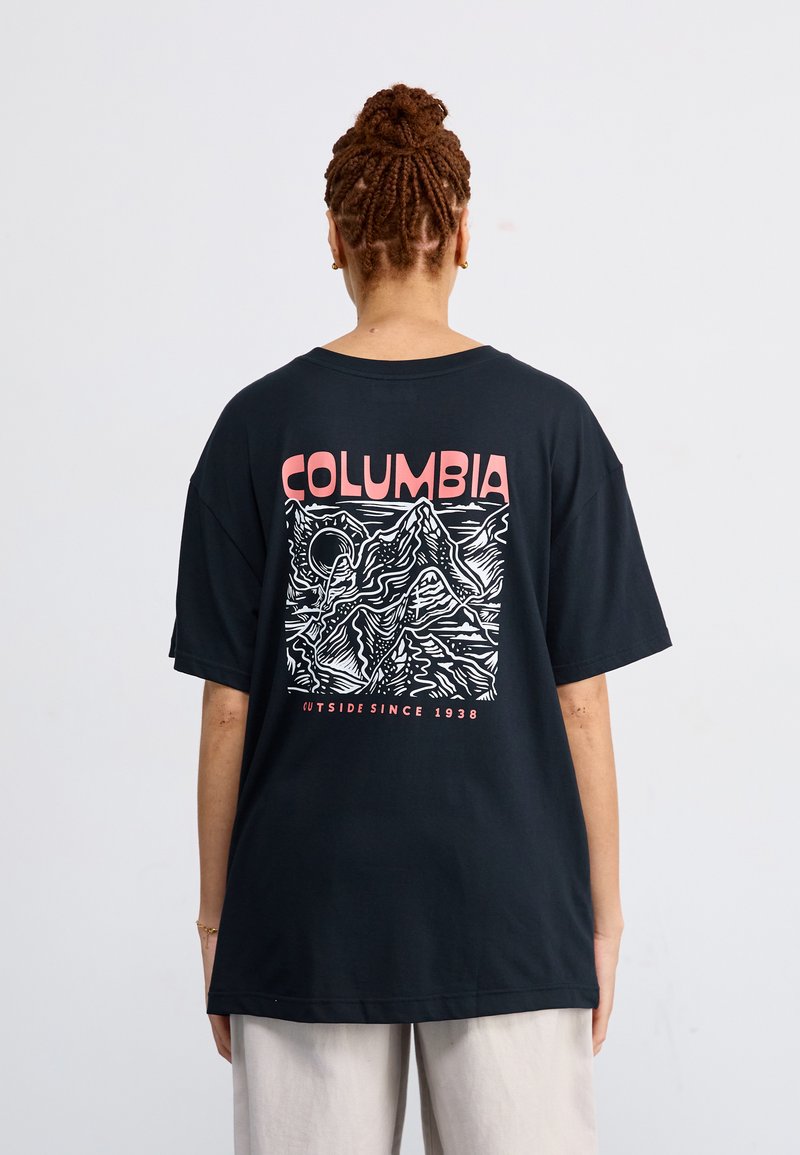 Black oversized t-shirt with a white mountain graphic and "COLUMBIA" in pink on the back, short sleeves, and a relaxed fit.