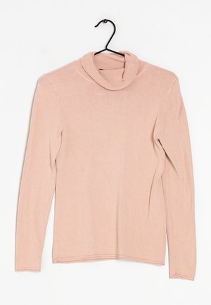 Light pink long-sleeve turtleneck sweater hanging on a black hanger against a white background.