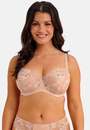 Sujetador beige con bordado floral en tonos rosas, con aros de sujección, material translúcido, tirantes ajustables y un pequeño lazo en el centro.