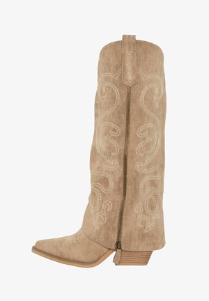 Tan suede cowboy boot with intricate white stitching, pointed toe, side zipper, and a stacked heel. Features a decorative back panel.