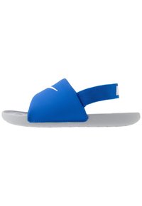 Blue slide sandal with a textured upper, elastic strap, and gray rubber sole. Features a white logo on the upper. Lightweight and flexible design.