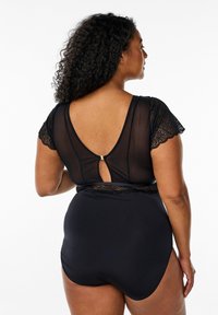Black swimsuit with sheer lace sleeves and a keyhole back. Fitted design with smooth texture and scalloped lace detailing at shoulders.