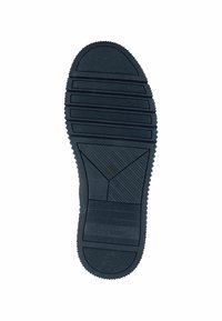 Black rubber shoe sole with textured grooves and patterns for grip, featuring a rounded toe and serrated edges along the perimeter.