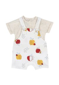 Pantalones de tirantes blancos con patrones de frutas coloridas; manzanas rojas y peras amarillas. Camisa de manga corta beige con manchas multicolor. Tejido de algodón suave.