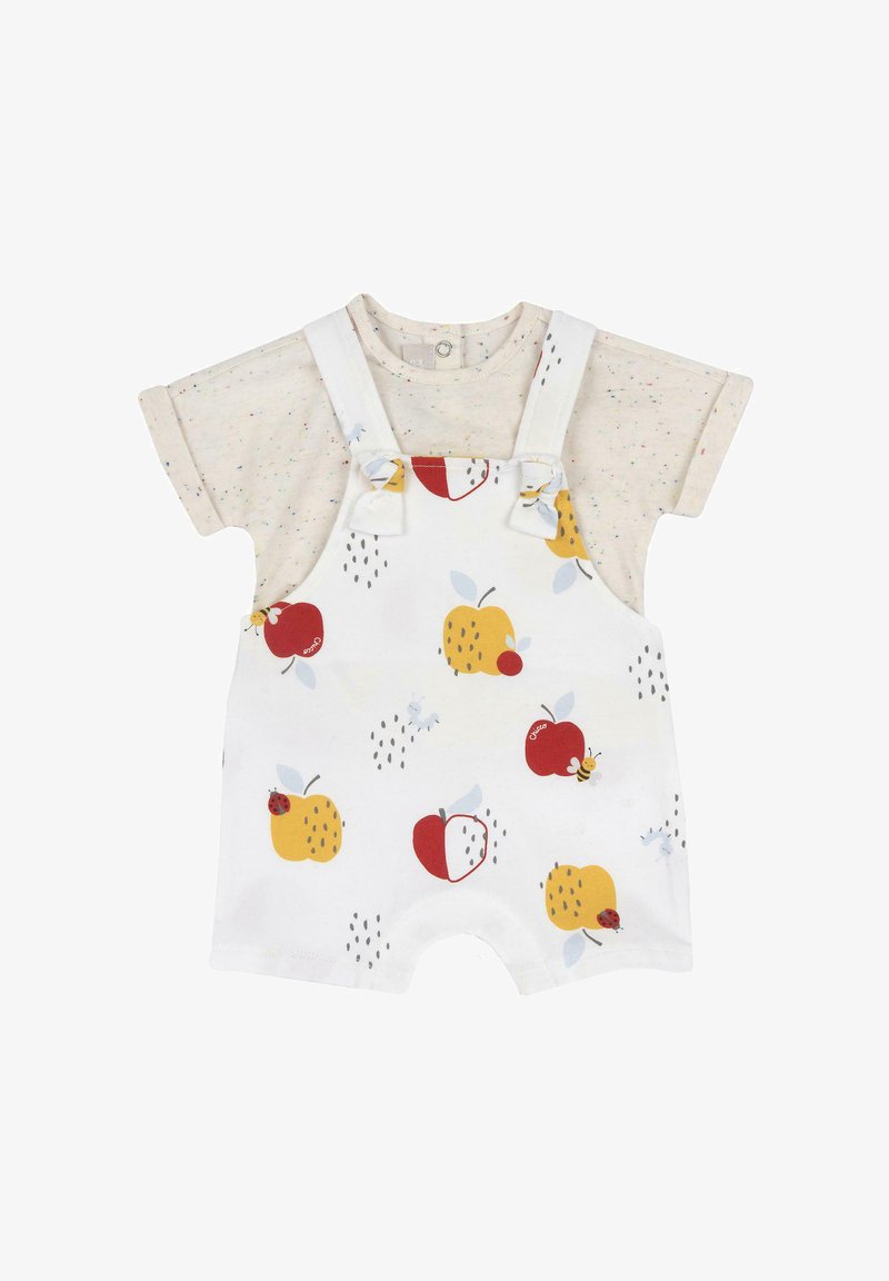 Pantalones de tirantes blancos con patrones de frutas coloridas; manzanas rojas y peras amarillas. Camisa de manga corta beige con manchas multicolor. Tejido de algodón suave.