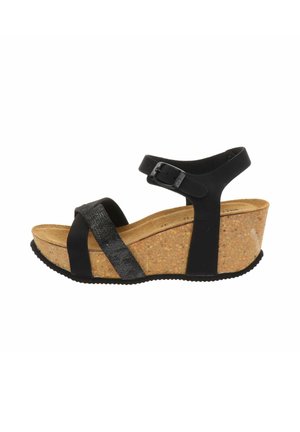 Sandalo con zeppa nero con suola in sughero, cinturino regolabile alla caviglia e due cinturini frontali che si incrociano sulle dita, mostrato su sfondo bianco.