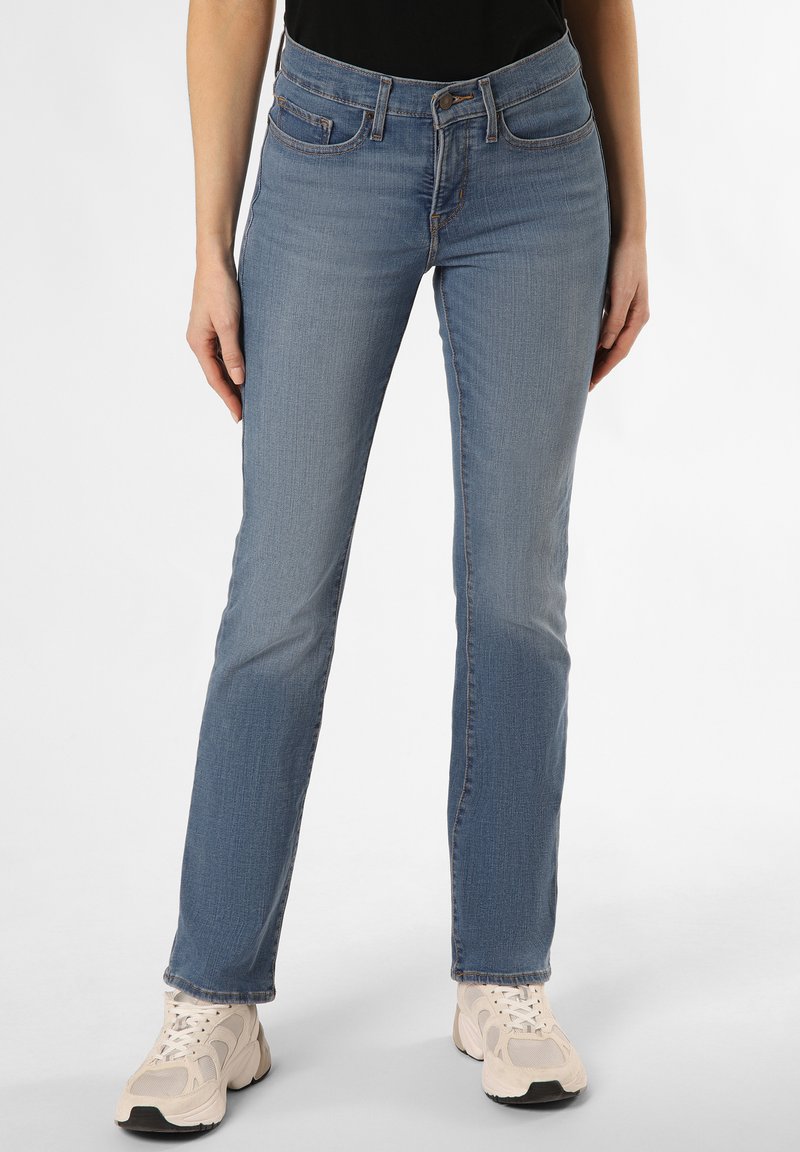 Light blue denim jeans with a straight leg design, five-pocket style, and subtle fading. Paired with beige sneakers.