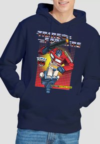 Navy blue hoodie featuring a graphic of Optimus Prime from Transformers, displaying vibrant colors, with bold text and logo details.