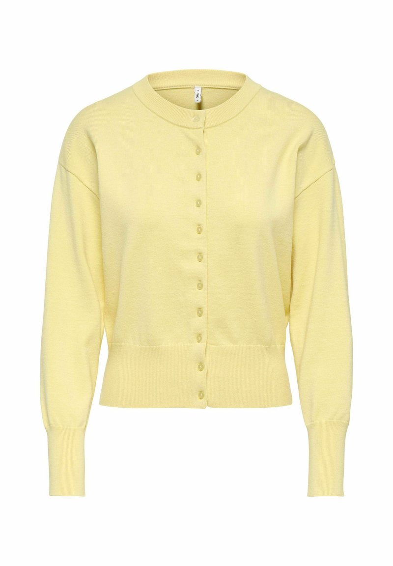 Gaiši dzeltena, garām piedurknēm ar pogām aiztaisāma jaka ar ribotu aproču, apakšmalu un apaļu kakla izgriezumu uz baltas fona.