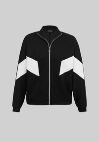 Veste noire zippée avec des bandes en chevrons blanches sur les manches et l'avant, col montant, et poignets et ourlet côtelés.