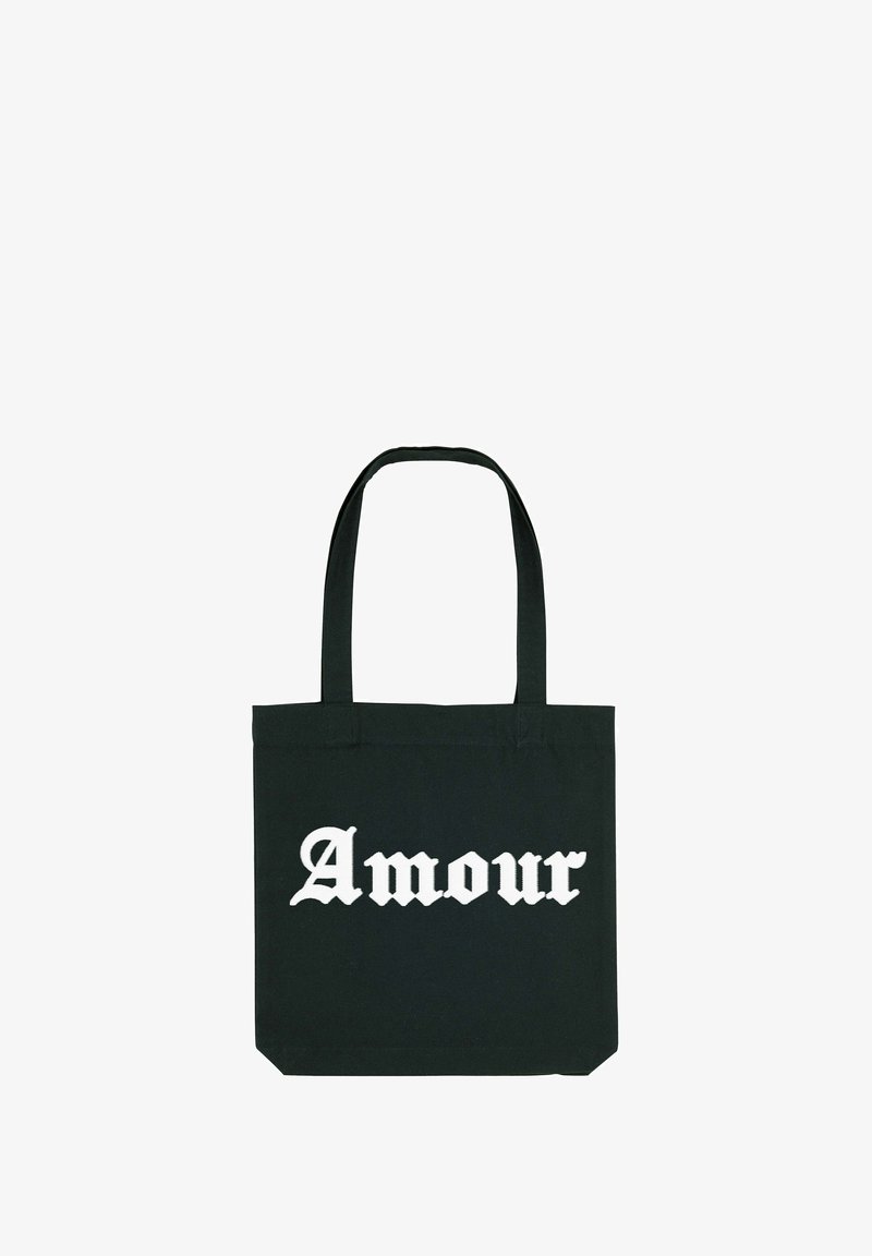 Sac fourre-tout noir avec deux poignées arborant le mot "Amour" en grandes lettres blanches de style gothique, centré sur le devant.