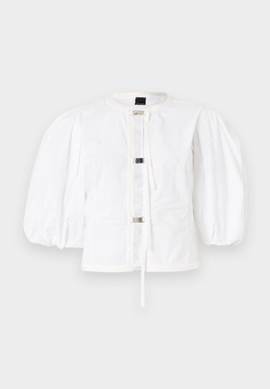 Giacca bianca con maniche a sbuffo, dalla linea dritta, con chiusura anteriore con fibbie metalliche e scollatura rotonda. Tessuto di cotone liscio.