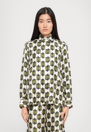 Green and white patterned long-sleeve shirt with a collared neckline and button closure, featuring circular designs in varying sizes.