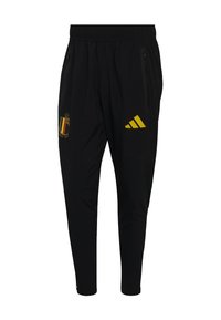 Crne sportske hlače s elastičnim pojasom, džepovima sa strane na patentni zatvarač, žutim Adidas logotipom na desnom bedru i grbom nogometne reprezentacije Belgije na lijevom bedru.