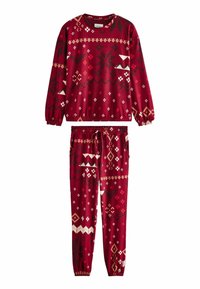 Punane pullover ja püksid, mis on valmistatud pehmest kangast, valgete ja mustade geomeetriliste mustritega. Mansetid ja vöökoht on elastsed.