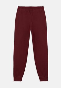 Burgundské tepláky s elastickým pásom a zoštíhlenými manžetami. Vyrobené z mäkkého materiálu, s hladkým povrchom a bez viditeľných potlačí.