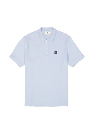Light blue polo shirt made of textured fabric, featuring a collar, two buttons, and a small black logo patch on the chest.