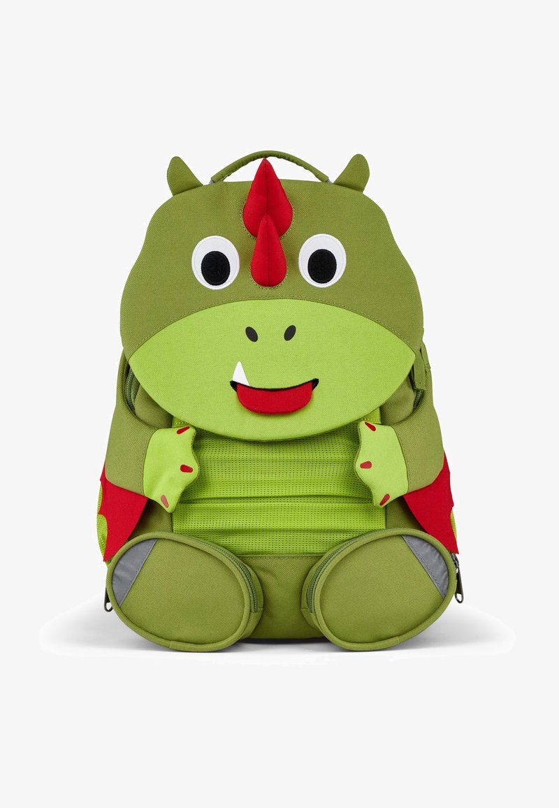 Grüner dinosaurierförmiger Rucksack mit einem großen lächelnden Gesicht, roten Akzenten und strukturiertem Stoff. Besitzt einen gerundeten Boden und seitliche Reißverschlusstaschen.