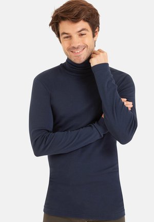 T-shirt à manches longues en turtleneck de couleur marine, en tissu doux, au design ajusté avec une texture lisse, avec des manches longues et un col haut.