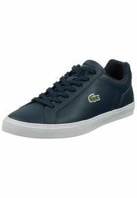 Navy blue leather sneakers with white rubber sole, featuring flat laces and a small green embroidered crocodile logo on the side.