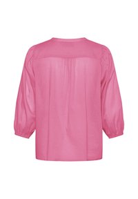 Blouse rose ample avec manches longues ballon, encolure ronde et un détail de pli dans le dos. Confectionnée en tissu léger.