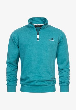 Suéter verde azulado con cuello de media cremallera, mangas largas, un logo en el pecho y puños y dobladillo acanalados. Hecho de un material suave y texturizado.