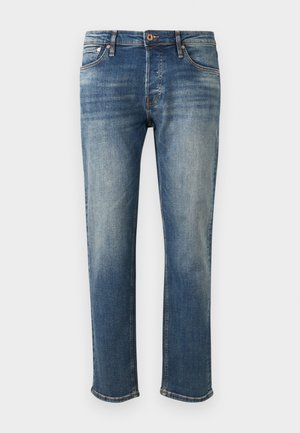 Blå denimjakker med en rett bendesign. Har lett falming, sydd detaljer og en rå kant ved mansjettene. Standard fem-lommers stil.