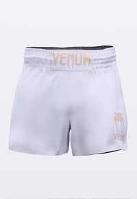 White Venum shorts featuring a gold logo at the waistband and on the side, crafted from smooth, lightweight fabric with an elastic waistband.