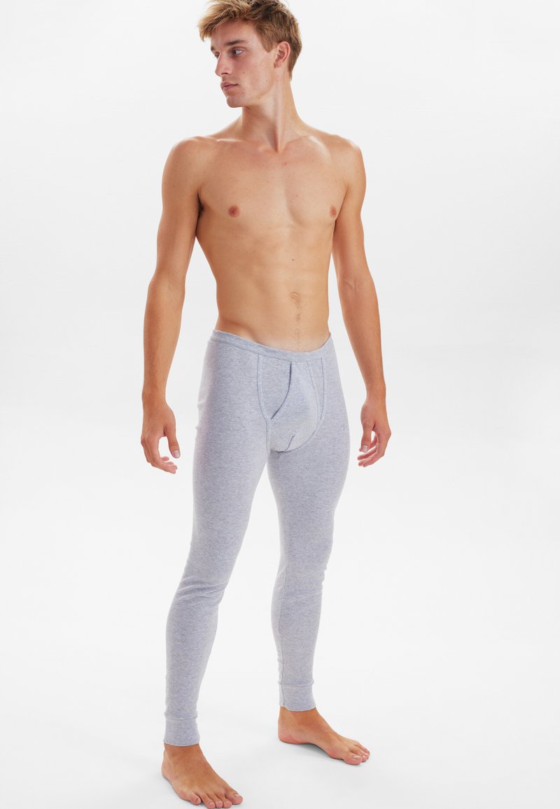 Gray cotton leggings with a fitted design and ribbed cuffs, featuring a front opening for ease. Smooth texture and lightweight material.