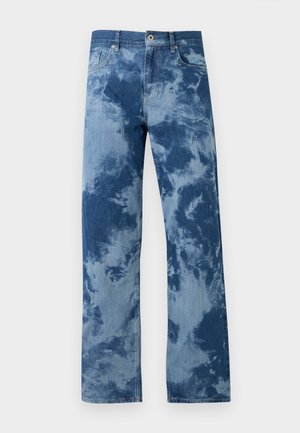 Sinised teksad lipsu-värvitud mustriga, sirgete säärtega, ees nööpide ja luku, viie taskuga, ühtlasel taustal.