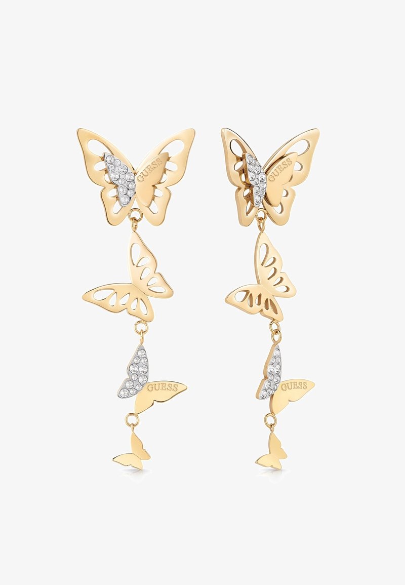 Boucles d'oreilles pendantes en forme de papillon doré avec des accents en cristal et "GUESS" gravé sur une aile de chaque papillon.