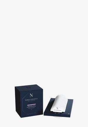 Crème réparatrice reset Noble Panacea avec boîte marine et applicateur crème blanc incurvé sur base marine, mettant en valeur un emballage de soins de la peau de luxe.