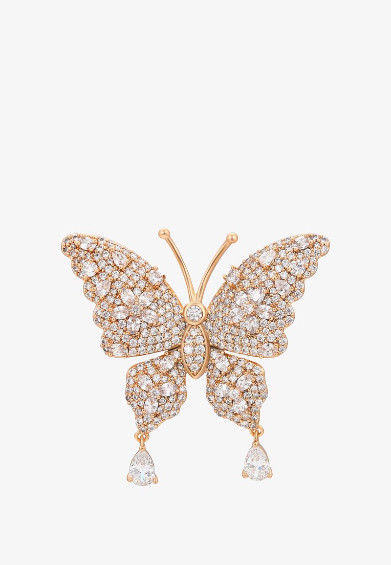 Brošňa v tvare motýľa s obrysom z ružového zlata, osadená jasnými trblietavými diamantmi a dvoma hruškovými diamantovými kvapkami na dolných krídlach.